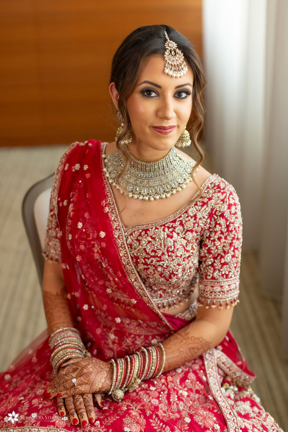 Bride to be in full Indian attire - wearing red and gold lehenga and bangles at the Langham, London